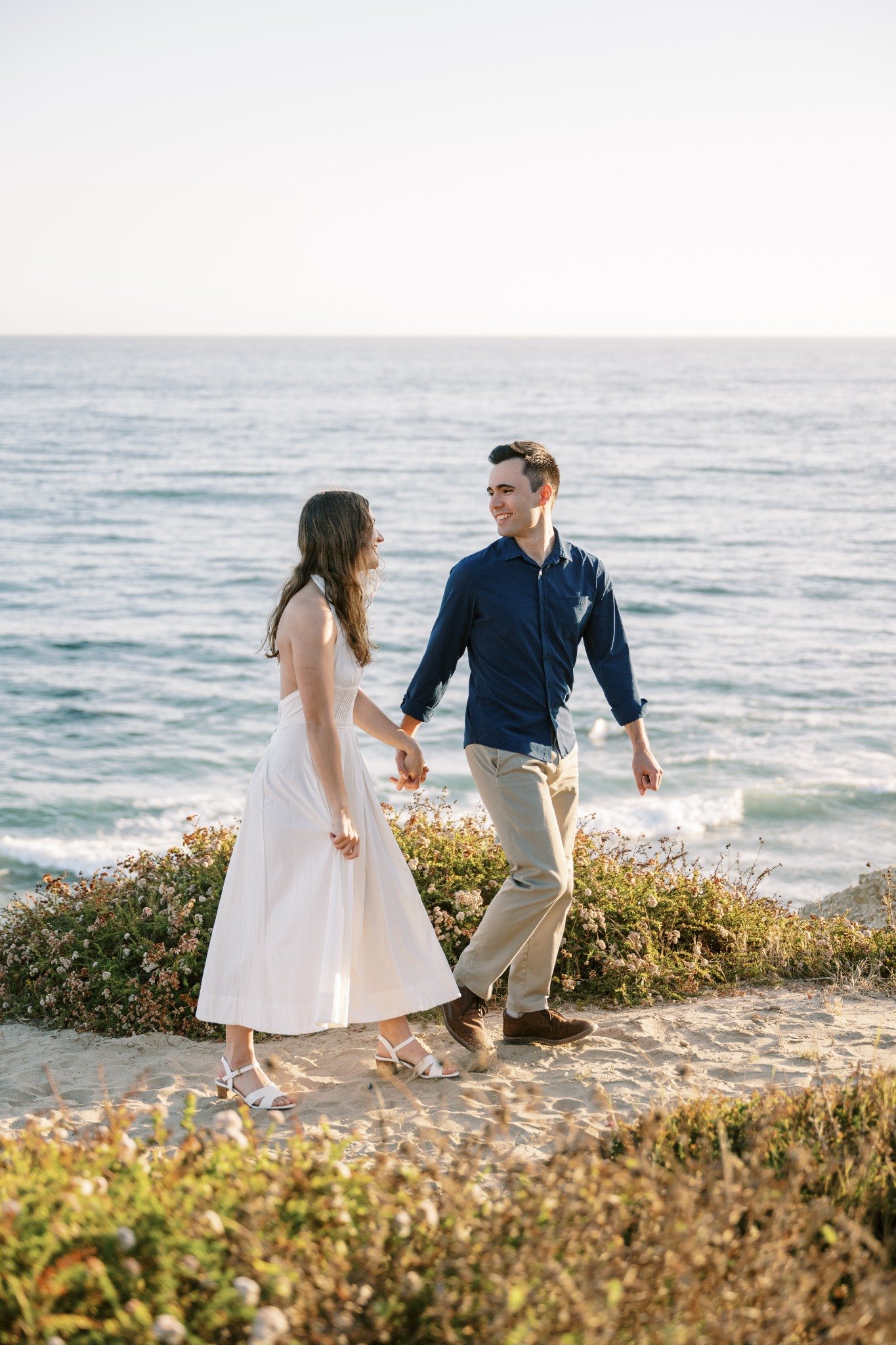 Molly and Nick walking on a coastal bluff